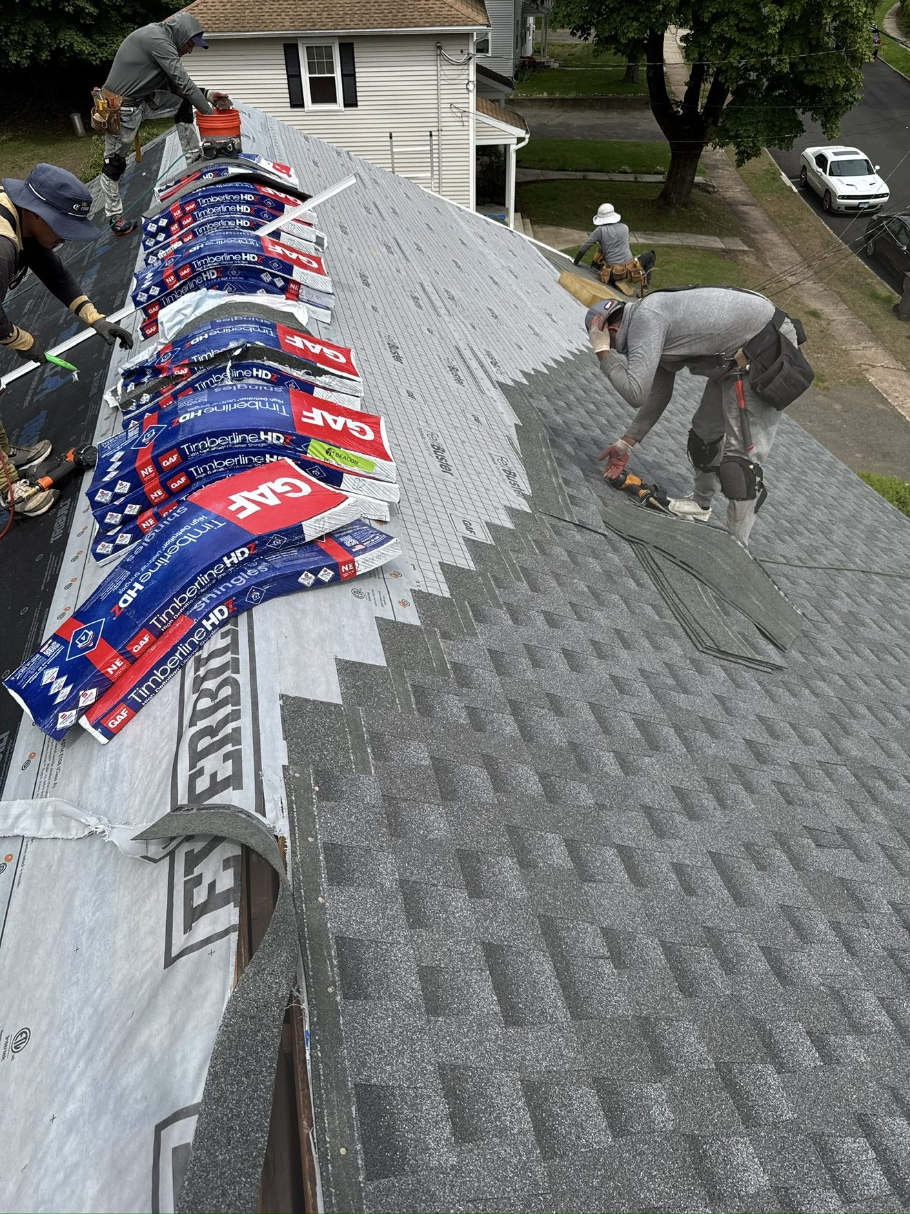 Next Gen Construction crew installing architectural shingles on a Connecticut roof