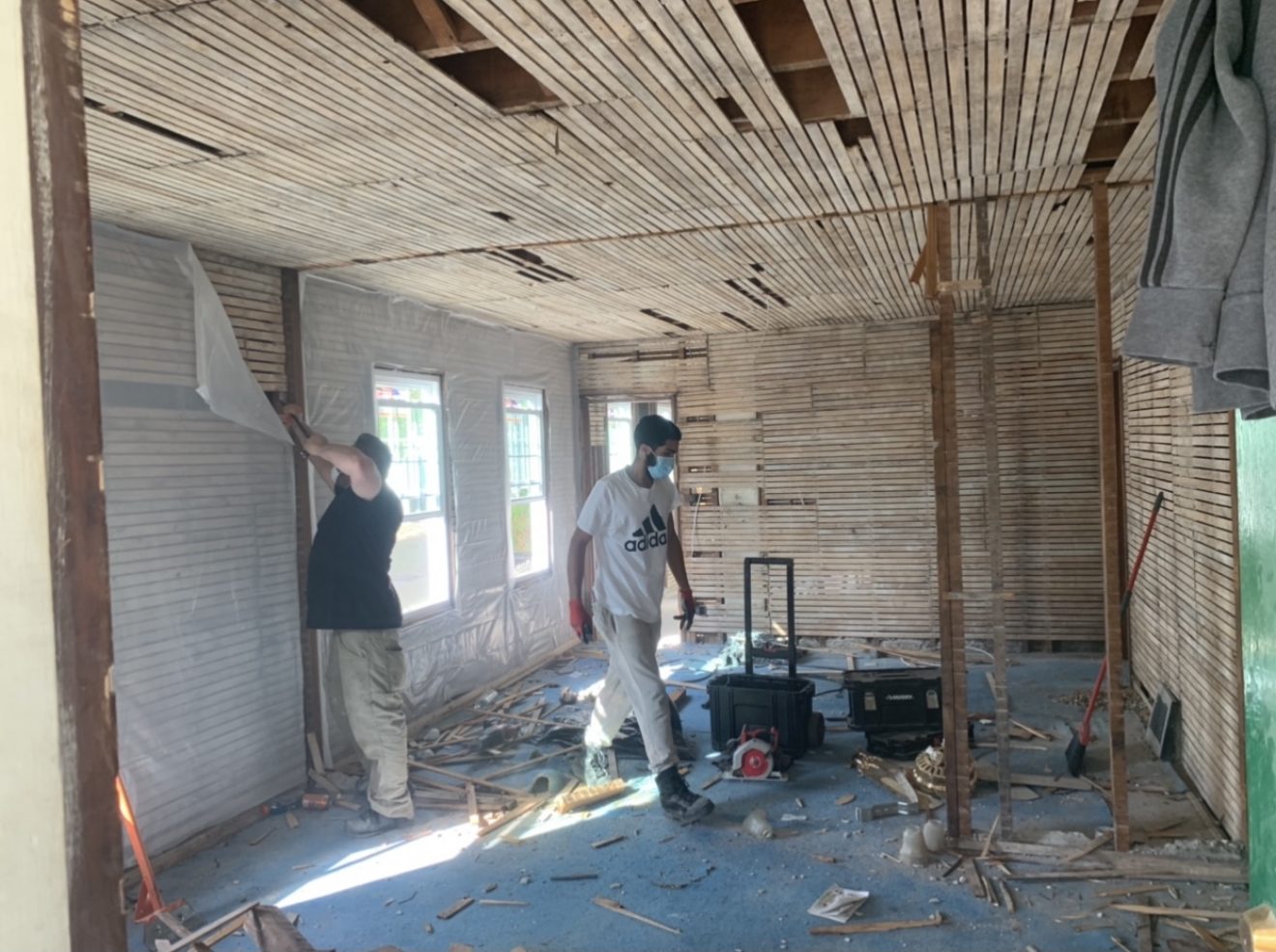Next Gen Construction crew members performing interior demolition during a full home renovation